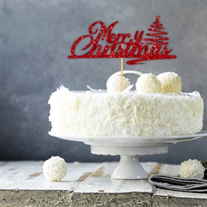 Detail of red glitter Merry Christmas cake topper with festive tree and wooden stick