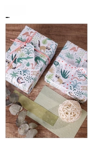 Detailed jungle animal gift wrap set with ribbons and animal tags on wood background