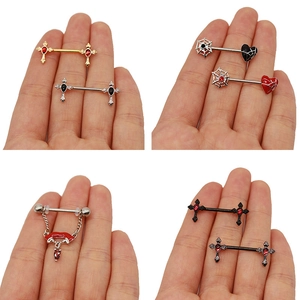 Macro display of assorted nipple ring designs including cross and spider web styles