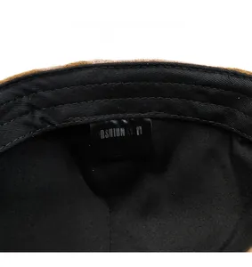 Detailed close-up of the internal care label on a vintage newsboy hat lining