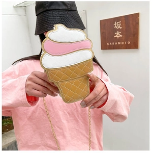 Close-up of ice cream shaped crossbody bag with pink leather and gold chain strap