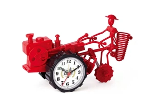 Detailed view of red tractor shaped desk clock with metal wire frame and white dial