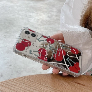 Detail view of transparent mirror phone case with cute cherry pattern and summer text