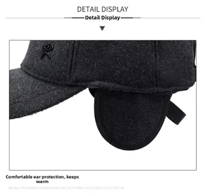 Detail view of winter earflaps on dark grey wool baseball cap with letter R logo