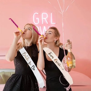 Fashionable white and pink satin sashes for bride and bridesmaids at bachelorette parties