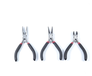 Close-up of three DIY jewelry pliers with anti-slip handles for precision craft work