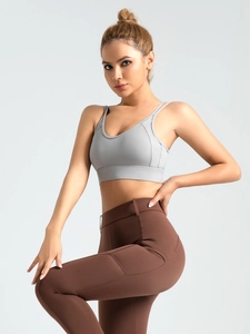 Cross-back sports bra with adjustable straps and high-waist yoga leggings in grey and brown