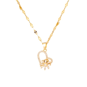 Macro detail of golden heart pendant with embedded zircons on a delicate lip link chain