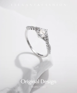 Macro shot of silver crown engagement ring with brilliant-cut moissanite and pave setting