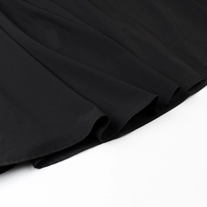 Detail of double-stitched hem on high-waisted black sleeveless dress with structured fabric