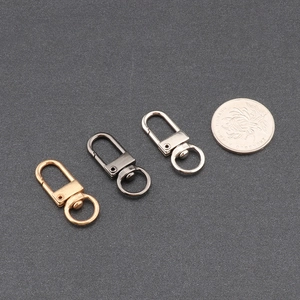 Zinc alloy lobster clasp set in gold, gun black, and silver with a coin for size reference