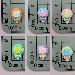 Mini resin lollipop charms with bows in assorted pastel colors measuring 1.5 cm