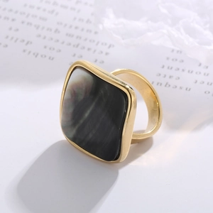 Detail of square black shell inlay on a vintage gold stainless steel ring for women