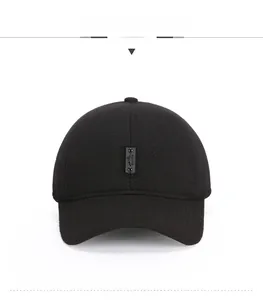 Close-up of a black winter baseball cap with sports patch and thick wool texture