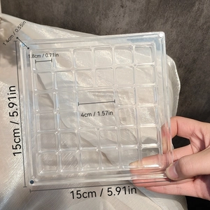 Macro shot of clear acrylic storage box with precise grid size markings for shells