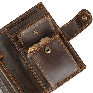 Macro shot of dark brown genuine leather wallet with card slots and snap coin pocket