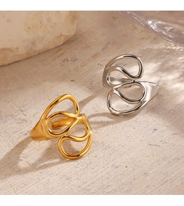 Detailed close-up of abstract hollow line rings in gold and silver stainless steel
