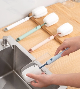 Detail of colorful long handle sponge cup brushes for cleaning bottles and glassware