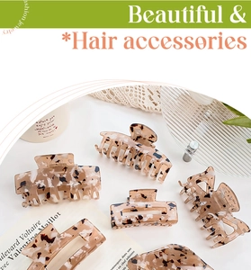 Set of five tortoiseshell hair claws in varied shapes on an elegant home decor background