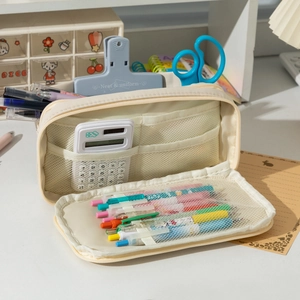 Detailed interior of a beige canvas pencil case showing mesh pockets and stationery storage