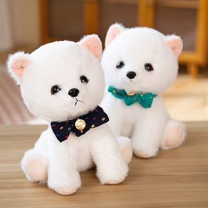 Cute white Pomeranian plush toys with polka dot bows on a cozy wooden surface