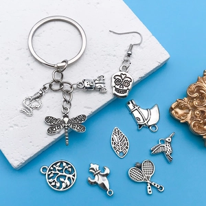 Detailed view of vintage silver alloy charms featuring angel bears and mixed animal motifs