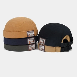 Detail of adjustable strap and vintage patches on colorful cotton docker hats