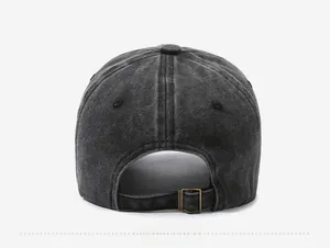 Detail view of the washed cotton baseball cap featuring an adjustable brass metal buckle
