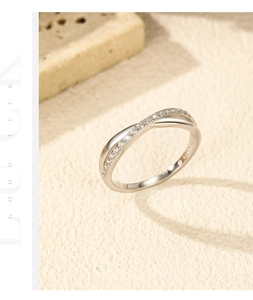 Macro detail of S925 sterling silver crisscross ring with pavé setting on a textured base
