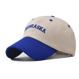 Detailed blue Nebraska embroidery on beige cotton twill baseball cap with curved brim