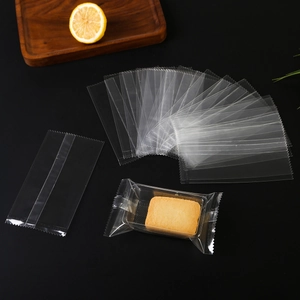 Clear food-grade plastic packaging bags for snacks and cookies on a dark background