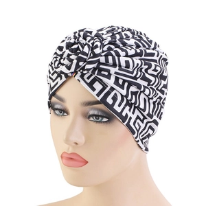 Detail of printed turban showing black and white geometric pattern and twist front design