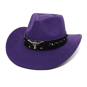 Close-up of purple wool cowboy hat featuring a gold bull head emblem and metal studs