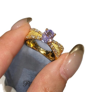 French vintage gold-toned open ring featuring a purple oval stone and striped zircons