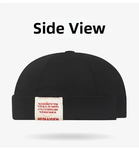 Side view of black docker hat showing twill cotton texture and woven label detail