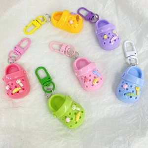Colorful mini clog shoe keychains in six pastel colors on white background