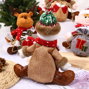 Handmade Christmas drawstring gift bags featuring snowman, reindeer, and Santa Claus dolls