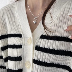 Close-up of 925 sterling silver heart necklace with asymmetric chain and toggle clasp