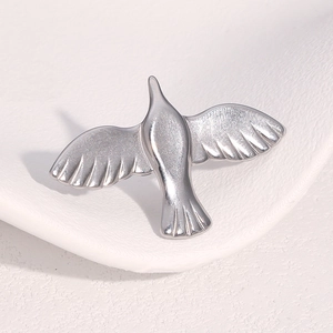 Macro shot of silver bird open ring with polished stainless steel wings and sleek finish