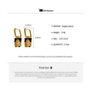 Detail showing gold lion head earrings with black inlay, copper and zircon materials