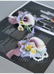 Close-up of PU calla lily boutonnieres with purple gradient petals and lace ribbon detail