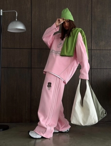 Detail of pink lounge set featuring side stripe patchwork and contrast green accessories