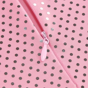 Detail of pink polka dot fabric with seamless invisible zipper on an elegant dress