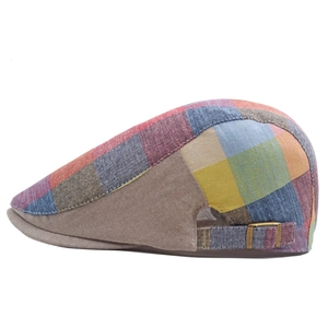 Close-up of a colorful plaid ivy cap featuring a vintage bronze metal adjustment buckle