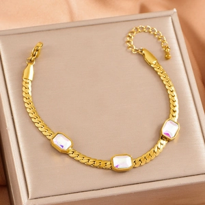 Detail of gold snake chain bracelet with three iridescent rectangular gemstones and clasp