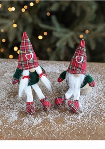 Detail of red plaid and green Christmas gnomes with knit hats and faux fur beards