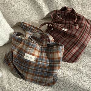 Close-up of retro plaid woolen tote bags with vintage checkered patterns and fabric labels