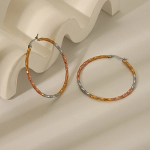 Three-tone twisted hoop earrings with gold, silver and rose gold textured metal finish