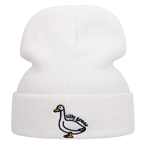 White knitted beanie featuring a cute 'silly goose' embroidered patch for winter