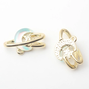 Detail view of golden moon and star alloy pendants with iridescent pearlescent resin inlay
